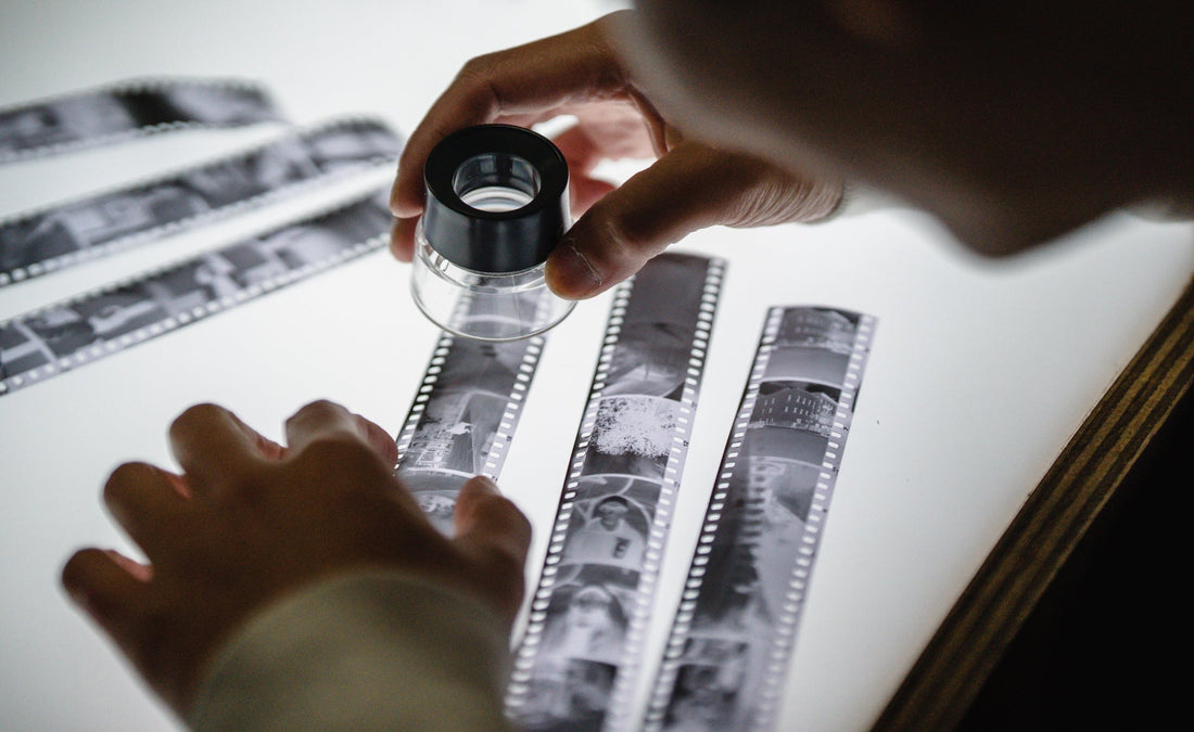 a man looking at negative film 