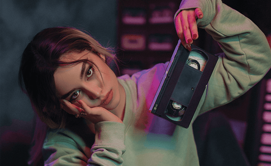 a woman holding an s vhs tape 