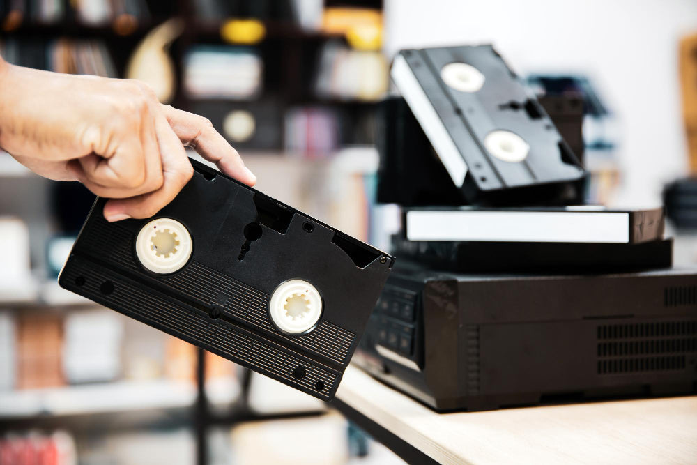 A person holding a vhs tape 