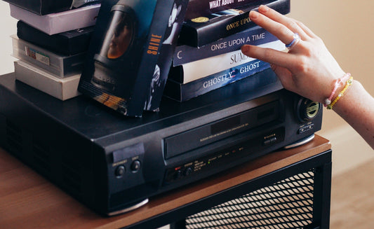 a person choosing a vhs tape to watch 