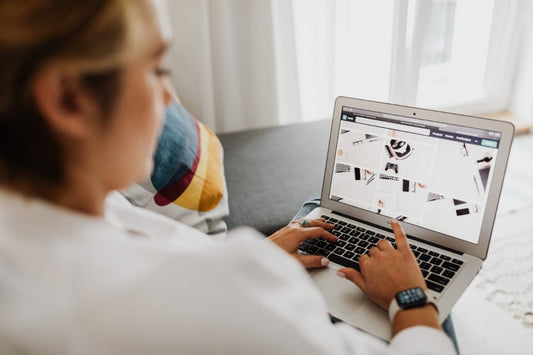 a woman looking at some photos on her laptop 