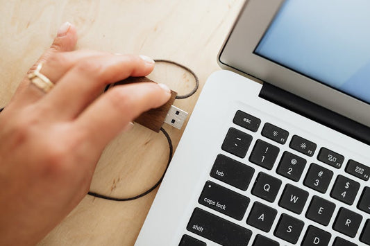 a person using a flash drive wondering about  thumb drive vs digital download