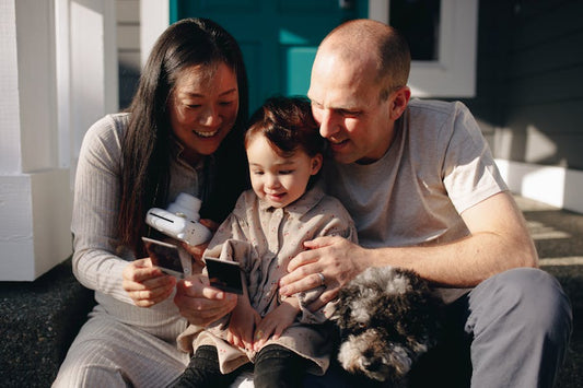 a happy family looking at the polaroids 
